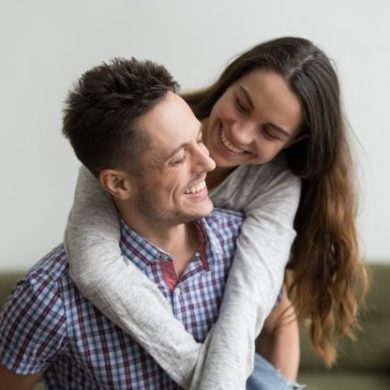 smiling-wife-laughing-embracing-young-husband-piggybacking-her-home_1163-4762